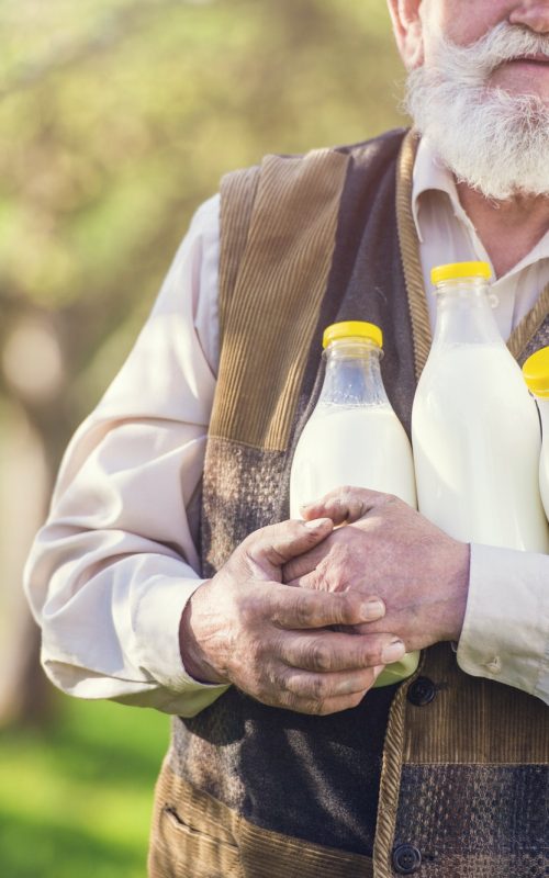 Farmer with compostable milk bottles